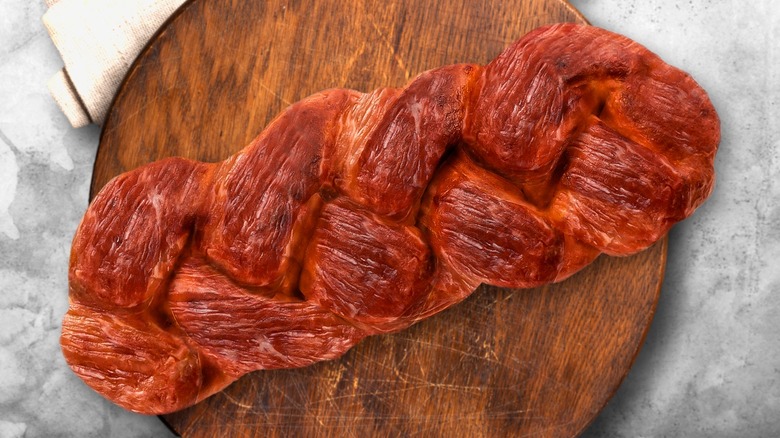 braided steak on wooden board