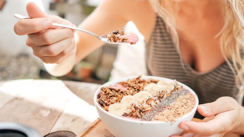 Woman eating breakfast bowl