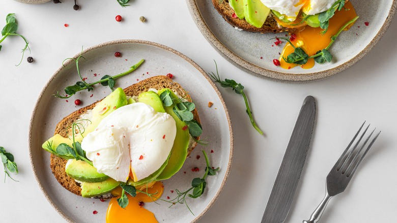 Poached egg, avocado, and greens on toast