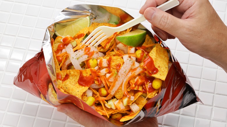 An open bag of chips displaying a walking taco