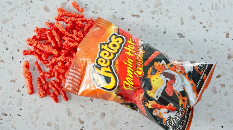 A bag of Flamin' Hot Crunchy Cheetos spilling out