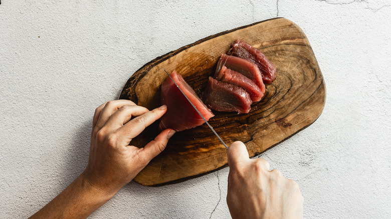 slicing raw tuna