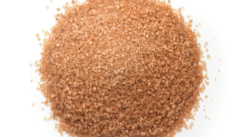 Close-up of turbinado sugar on a white background