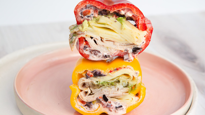 Two bell pepper sandwich halves, stacked on pink plate