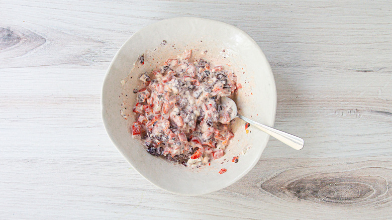 Olive cream cheese mix in white bowl