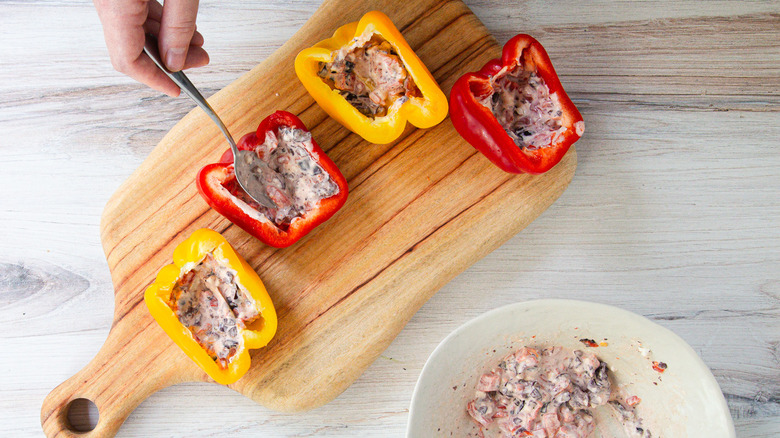 Spreading bell peppers with olive cream cheese