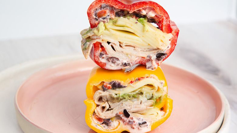 Two bell pepper sandwich halves, stacked on pink plate