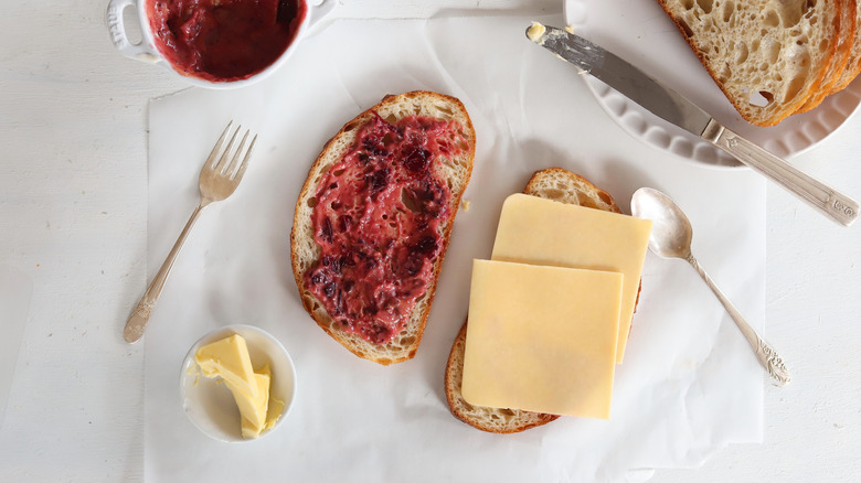 making sandwich with cranberry and cheese on bread