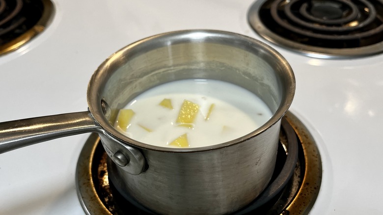 potatoes and milk in saucepan