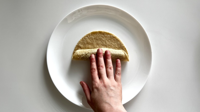 hand rolling tortilla