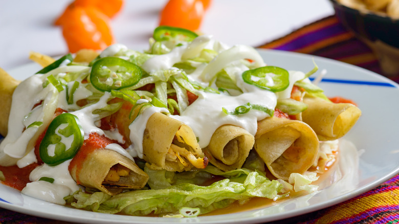 taquitos with crema and jalapenos