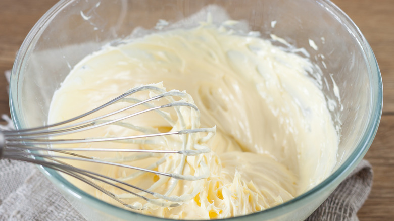 whisk in a mixing bowl with icing