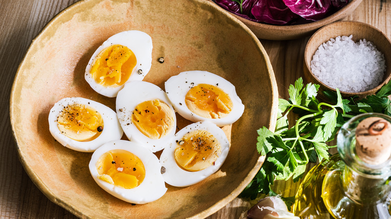 Bowl of boiled eggs and herbs