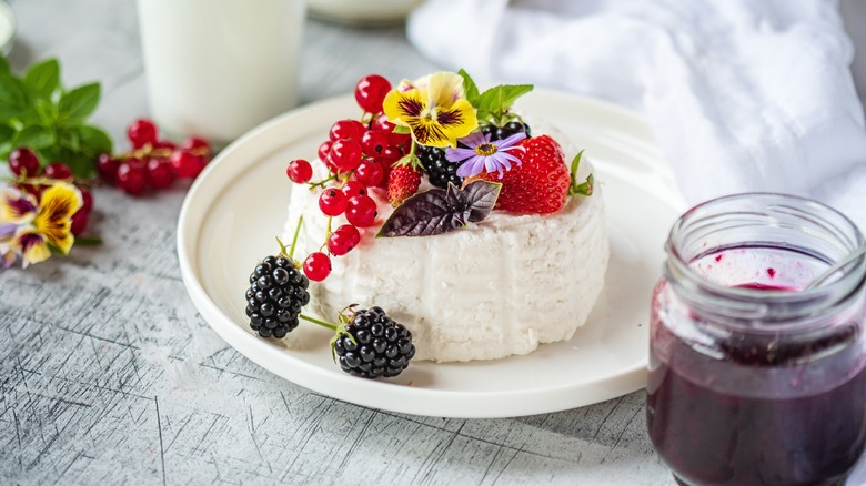 Goat cheese topped with fruits and flowers