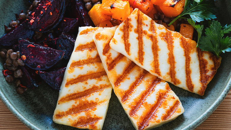 slices of halloumi in a bowl with figs and sweet potatoes