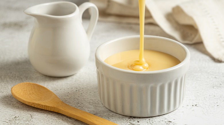 A condensed milk dripping into a ramekin