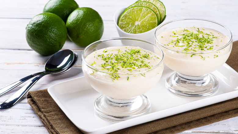 glasses of lime flavored mousse and fresh limes