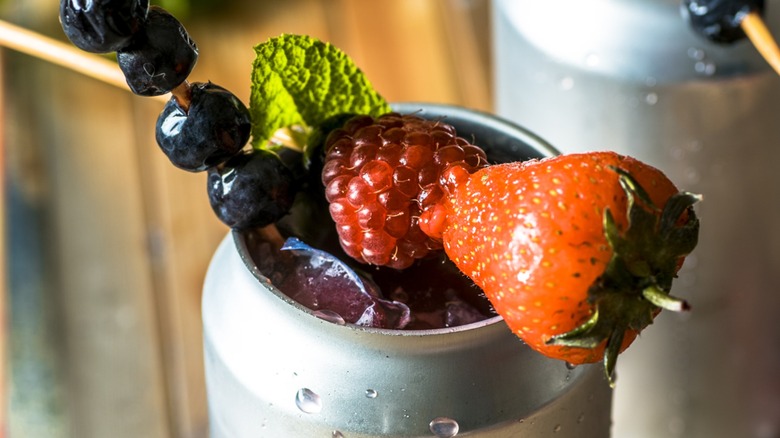 Close-up of an open can cocktail garnished with fruit