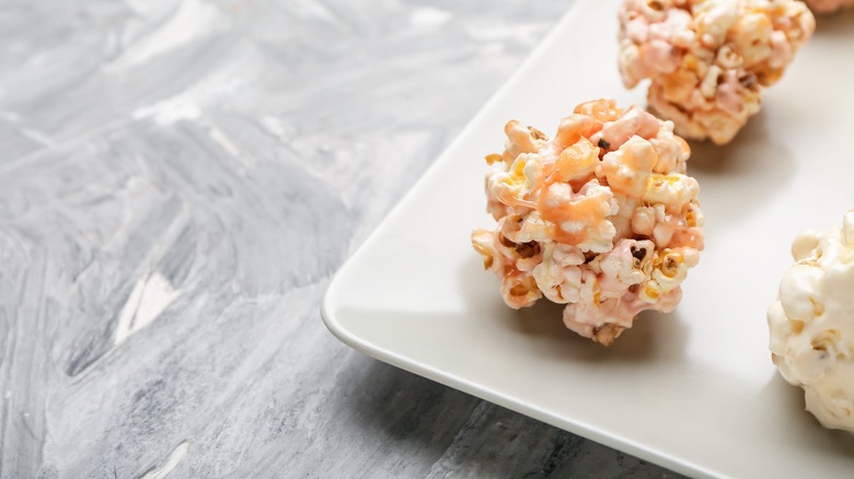 Pink popcorn balls on a white ceramic tray