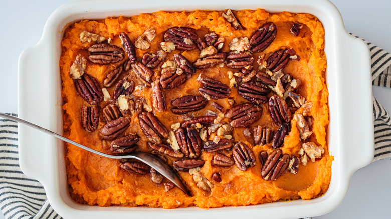 sweet potato casserole with pecans and walnuts on top