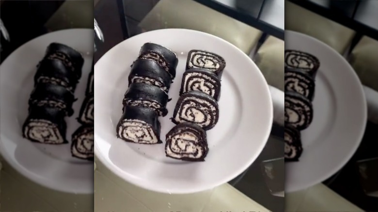 dipping Oreo sushi into chocolate
