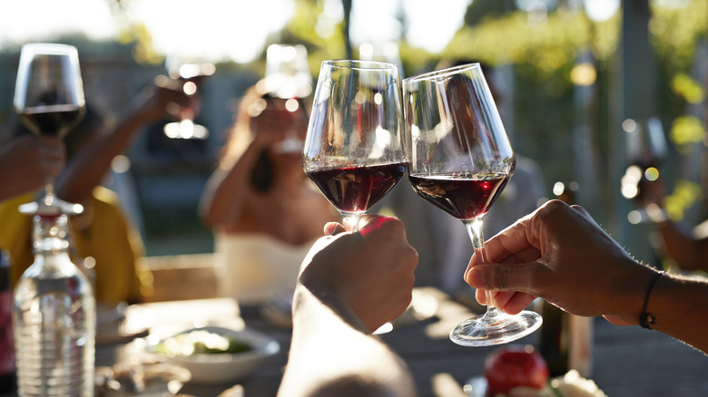 People clinking glasses of wine