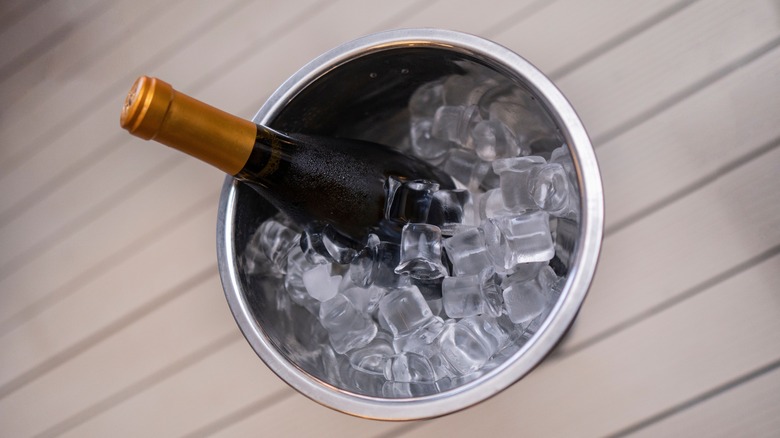 Bucket with ice and bottle of wine