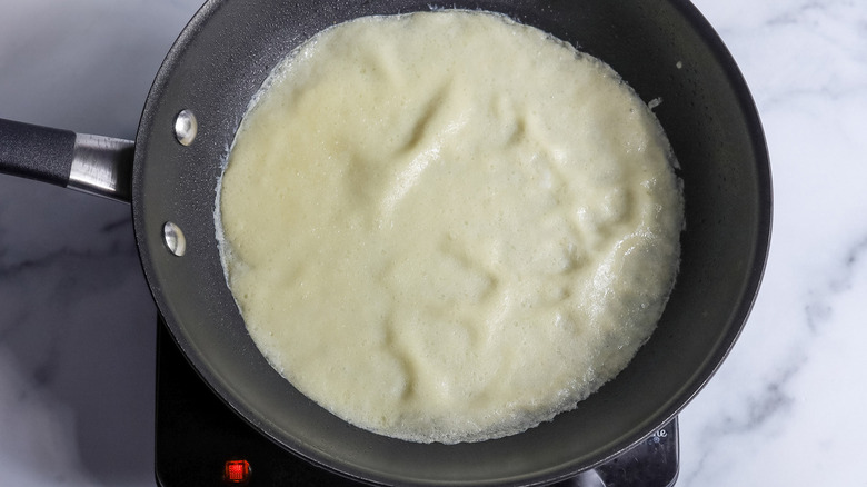 crespelle cooking in skillet