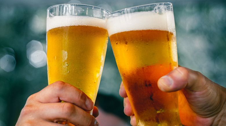 Two beer glasses in a toast