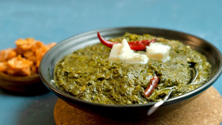 Bowl of saag on table