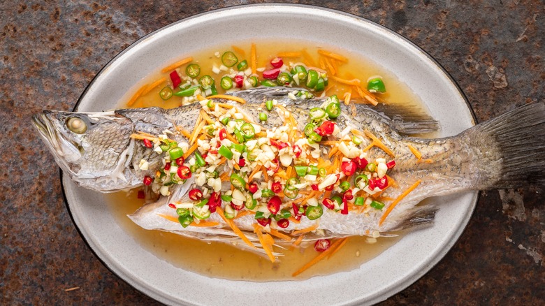 whole barramundi with chopped vegetables