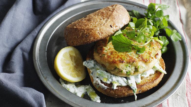 chicken sandwich with tzatziki in gray bowl