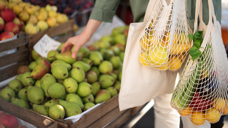 A person selecting fruit