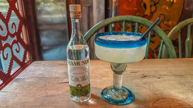 viamundi raicilla bottle next to margarita on table