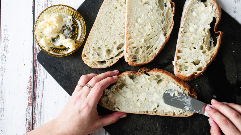 smearing bread with mayonnaise