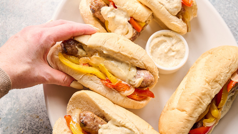 hand grabbing sandwich from plate