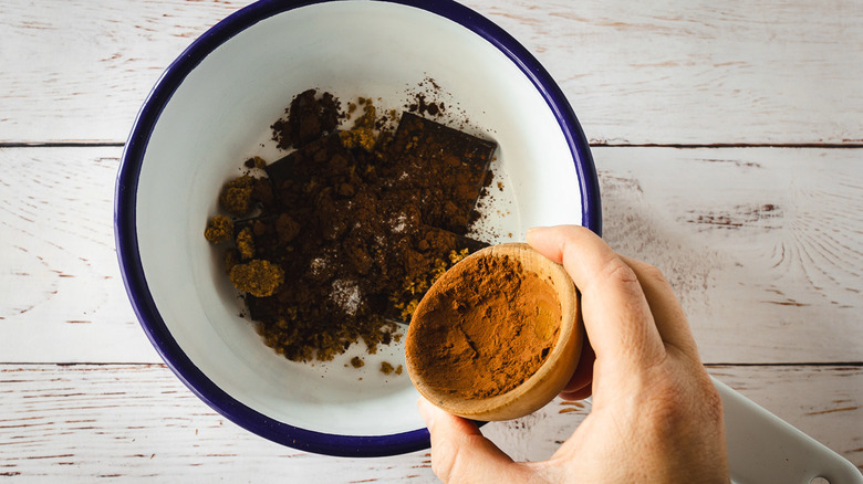 Adding cocoa powder to saucepan