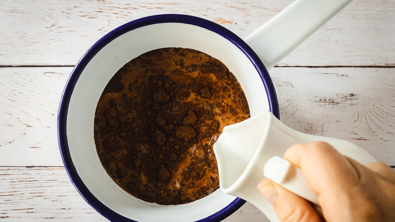 Adding milk to saucepan