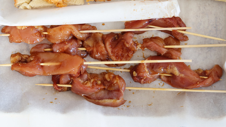 skewered chicken on parchment paper