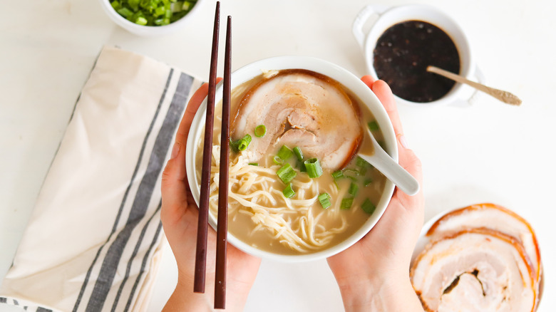 ramen noodle bowl in hands