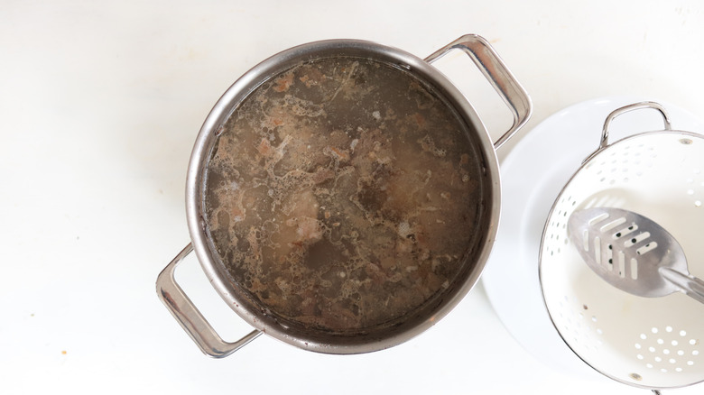 cooked pork bones in pot of water