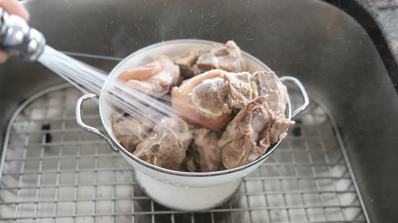 pork bones rinsed in a colander 