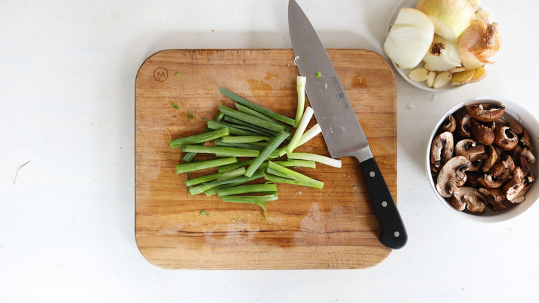 green onions cut on a cutting board