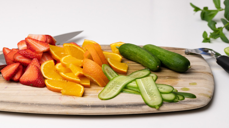 sliced oranges, strawberries, and cucumbers