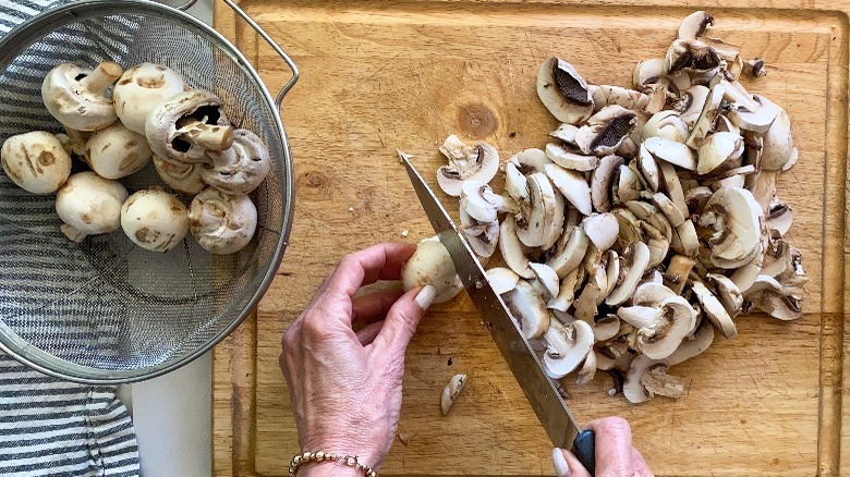 sliced mushrooms on board