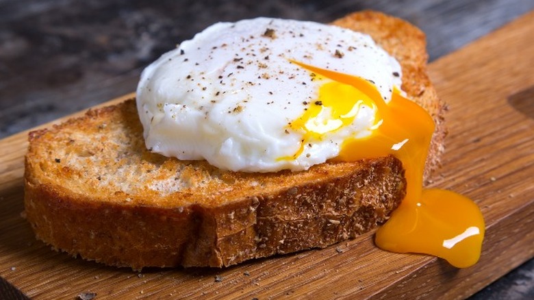 Runny poached egg on toast