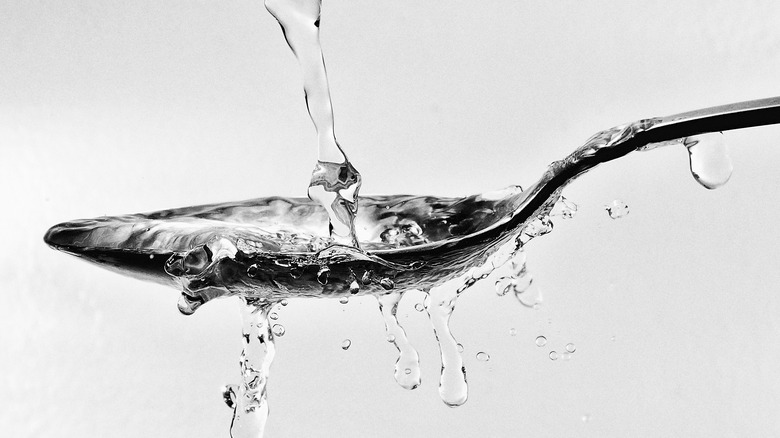 Water pouring into spoon