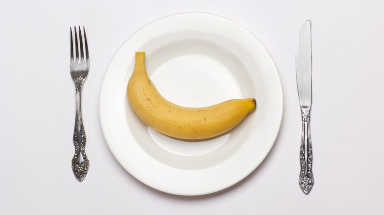 Banana on plate with cutlery