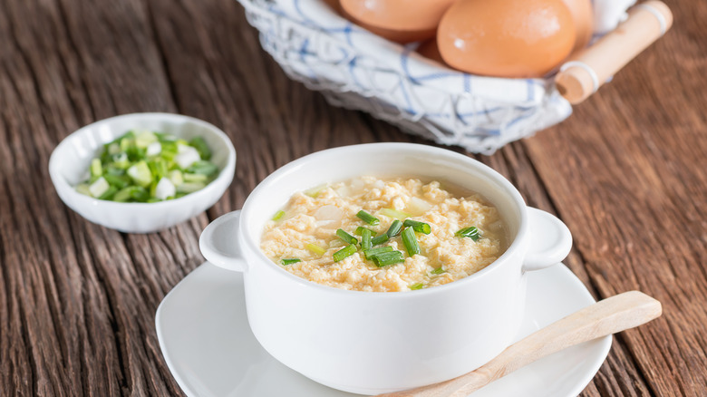 egg drop soup with eggs in background