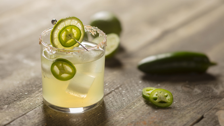 Spicy margarita with sliced jalapeño and lime